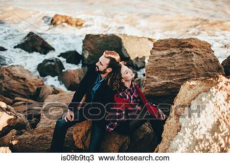 Romantic mid adult couple sitting back to back on beach rock, Odessa Oblast, Ukraine View Large Photo Image Stock Image - Romantic mid adult couple sitting back to back on beach rock, Odessa Oblast, Ukraine. Fotosearch