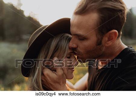 Romantic mid adult man kissing girlfriend on forehead in rural valley, portrait, Mineral King, California, USA View Large Photo Image Picture - Romantic mid adult man kissing girlfriend on forehead in rural valley, portrait, Mineral King, California, USA. Fotosearch