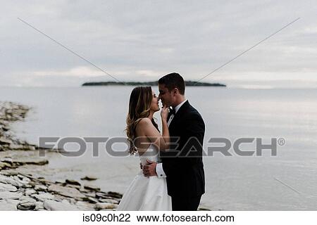 Romantic young bride and groom face to face on lakeside View Large Photo Image Stock Image - Romantic young bride and groom face to face on lakeside. Fotosearch