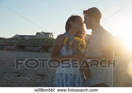 Romantic young couple face to face on beach at sunset, Spring Lake, New Jersey, USA View Large Photo Image Stock Image - Romantic young couple face to face on beach at sunset, Spring Lake, New Jersey, USA. Fotosearch