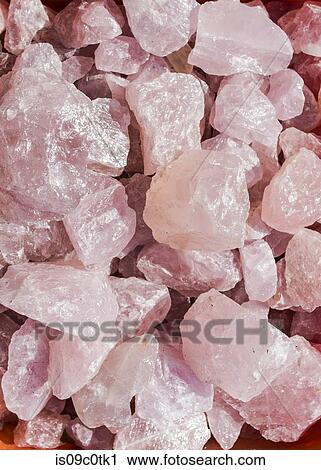 Stock Image - Rough rose quartz crystal rocks. Fotosearch