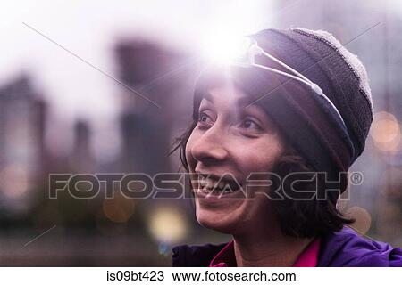 Stock Image - Runner with headlamp in urban North Vancouver, Canada. Fotosearch