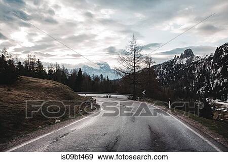 Rural road in snow capped mountains, Dolomites, Italy View Large Photo Image Stock Photo - Rural road in snow capped mountains, Dolomites, Italy. Fotosearch