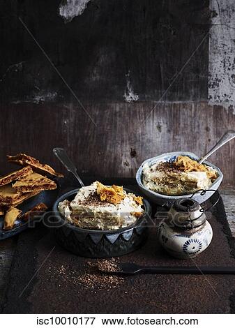 Rustic low key still life with bowls of tiramisu, chocolate and honeycomb on table View Large Photo Image Stock Photo - Rustic low key still life with bowls of tiramisu, chocolate and honeycomb on table. Fotosearch