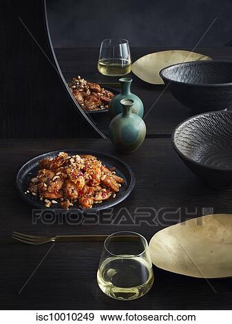 Rustic low key still life with plate of chilli plum fried chicken and mixed nuts on table View Large Photo Image Stock Photo - Rustic low key still life with plate of chilli plum fried chicken and mixed nuts on table. Fotosearch