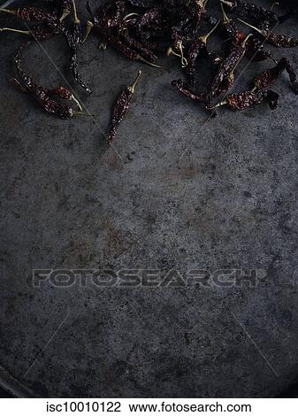 Rustic still life with scattered dried chillies, overhead view View Large Photo Image Stock Image - Rustic still life with scattered dried chillies, overhead view. Fotosearch