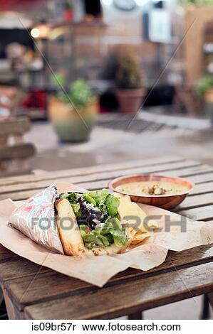 Salad wrap, potato chips and dip from food truck View Large Photo Image Stock Photography - Salad wrap, potato chips and dip from food truck. Fotosearch