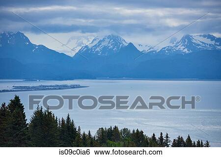 Stock Photograph - Scenic view of snow capped mountains, Homer, Alaska, United States. Fotosearch
