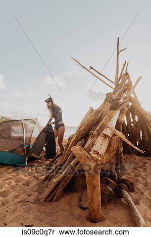 Stock Photography - Scuba diver camping on sandy beach, Princeville, Hawaii, US. Fotosearch