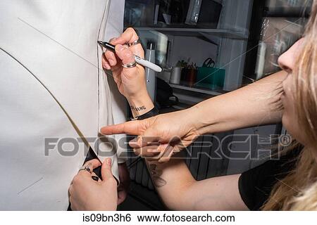 Seamstress marking tailored jacket on fit model View Large Photo Image Stock Photograph - Seamstress marking tailored jacket on fit model. Fotosearch