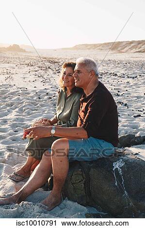 Senior couple enjoying sun on sandy beach View Large Photo Image Stock Image - Senior couple enjoying sun on sandy beach. Fotosearch