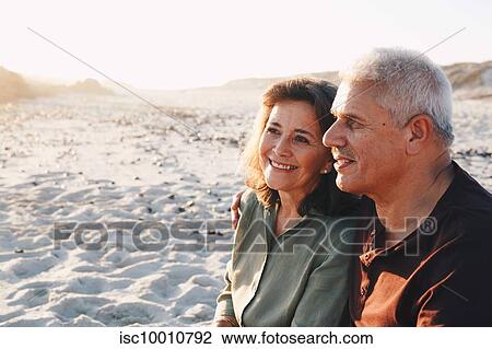 Senior couple enjoying sun on sandy beach View Large Photo Image Stock Image - Senior couple enjoying sun on sandy beach. Fotosearch