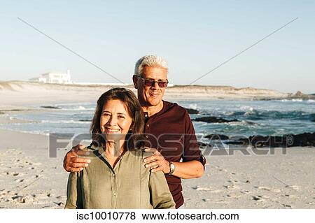 Senior couple enjoying sun on sandy beach View Large Photo Image Stock Photo - Senior couple enjoying sun on sandy beach. Fotosearch
