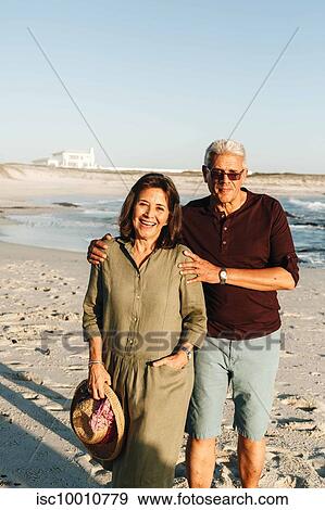 Senior couple enjoying sun on sandy beach View Large Photo Image Stock Photo - Senior couple enjoying sun on sandy beach. Fotosearch