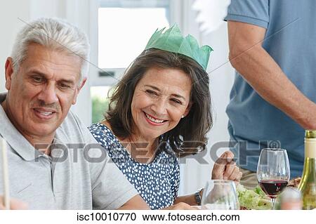 Senior couple listening attentively at dining table in home party View Large Photo Image Stock Image - Senior couple listening attentively at dining table in home party. Fotosearch