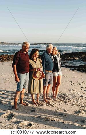 Senior couples enjoying sun on sandy beach View Large Photo Image Stock Photo - Senior couples enjoying sun on sandy beach. Fotosearch