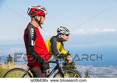Senior man and grandson, wearing cycling clothes, standing on hill, looking at view, Geneva, Switzerland, Europe View Large Photo Image Stock Photo - Senior man and grandson, wearing cycling clothes, standing on hill, looking at view, Geneva, Switzerland, Europe. Fotosearch