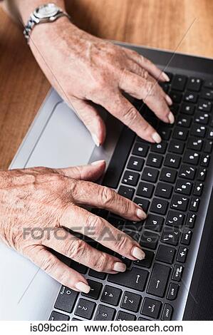 Picture - Senior woman using laptop, close-up. Fotosearch