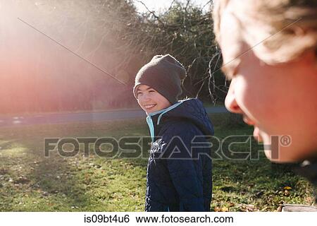 Siblings enjoying sun in garden View Large Photo Image Stock Photograph - Siblings enjoying sun in garden. Fotosearch