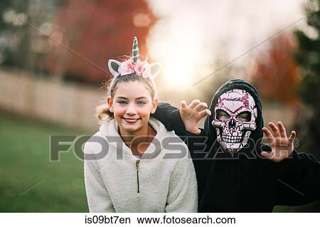 Siblings in halloween costume posing in park View Large Photo Image Picture - Siblings in halloween costume posing in park. Fotosearch