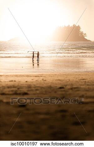 Silhouetted view of two surfers on beach at sunset, Tofino, Vancouver Island, Canada View Large Photo Image Stock Photo - Silhouetted view of two surfers on beach at sunset, Tofino, Vancouver Island, Canada. Fotosearch