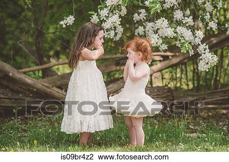 Sisters making faces at each other View Large Photo Image Stock Image - Sisters making faces at each other. Fotosearch