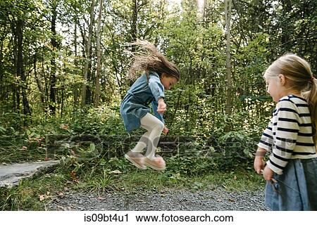 Sisters playing in forest View Large Photo Image Stock Image - Sisters playing in forest. Fotosearch