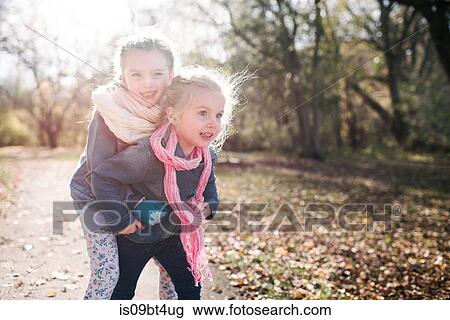 Sisters playing in forest View Large Photo Image Stock Image - Sisters playing in forest. Fotosearch