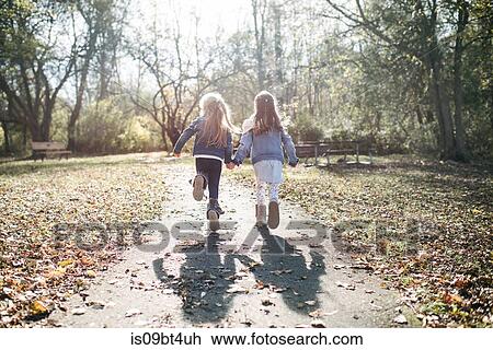 Sisters running in forest View Large Photo Image Stock Image - Sisters running in forest. Fotosearch