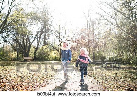 Sisters running in forest View Large Photo Image Stock Image - Sisters running in forest. Fotosearch