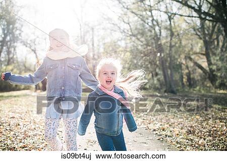 Sisters running in forest View Large Photo Image Stock Image - Sisters running in forest. Fotosearch
