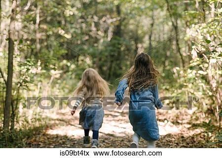 Sisters running in forest View Large Photo Image Stock Photo - Sisters running in forest. Fotosearch