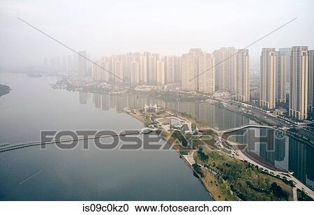 Skyscrapers lining river, Yingwanchen, Hunan, China View Large Photo Image Stock Image - Skyscrapers lining river, Yingwanchen, Hunan, China. Fotosearch