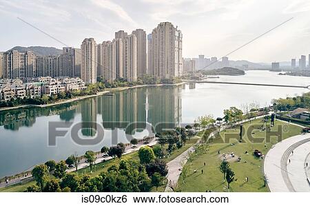 Stock Photograph - Skyscrapers lining river, Yingwanchen, Hunan, China. Fotosearch