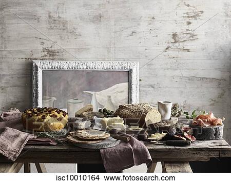 Spread of bread, cheese, figs and ham on table View Large Photo Image Picture - Spread of bread, cheese, figs and ham on table. Fotosearch