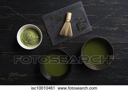 Still life of matcha tea preparation with whisk and bowls of matcha tea and tea powder, overhead view, low key View Large Photo Image Stock Image - Still life of matcha tea preparation with whisk and bowls of matcha tea and tea powder, overhead view, low key. Fotosearch
