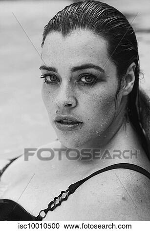 Sultry mid adult woman with wet hair leaning against outdoor swimming poolside, black and white head and shoulder portrait, Cape Town, South Africa View Large Photo Image Stock Image - Sultry mid adult woman with wet hair leaning against outdoor swimming poolside, black and white head and shoulder portrait, Cape Town, South Africa. Fotosearch