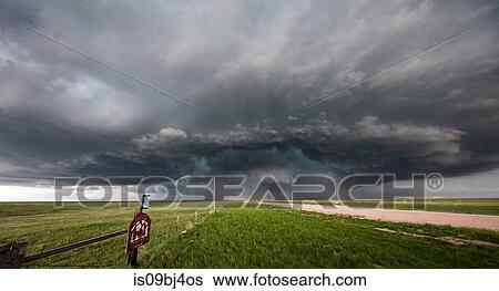 Stock Photograph - Supercell with embedded tornado spins over Wyoming, US. Fotosearch
