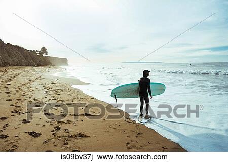 Surfer with surfboard on beach, Morro Bay, California, United States View Large Photo Image Stock Image - Surfer with surfboard on beach, Morro Bay, California, United States. Fotosearch