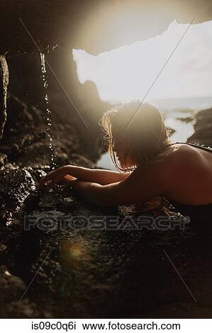 Swimmer by dripping water in seaside cavern View Large Photo Image Stock Image - Swimmer by dripping water in seaside cavern. Fotosearch
