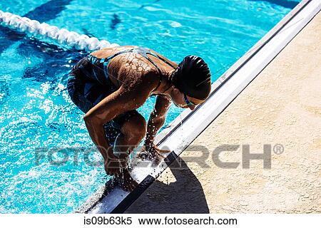 Stock Photography - Swimmer climbing out of pool. Fotosearch