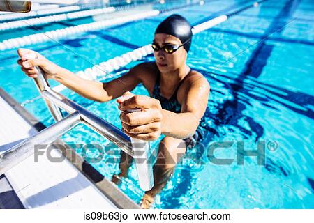 Swimmer in water at end of pool View Large Photo Image Picture - Swimmer in water at end of pool. Fotosearch