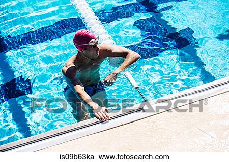 Swimmer in water at end of pool View Large Photo Image Stock Image - Swimmer in water at end of pool. Fotosearch