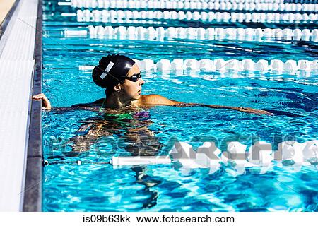 Stock Image - Swimmer in water at end of pool. Fotosearch