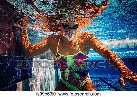 Swimmer in water at end of pool View Large Photo Image Stock Image - Swimmer in water at end of pool. Fotosearch
