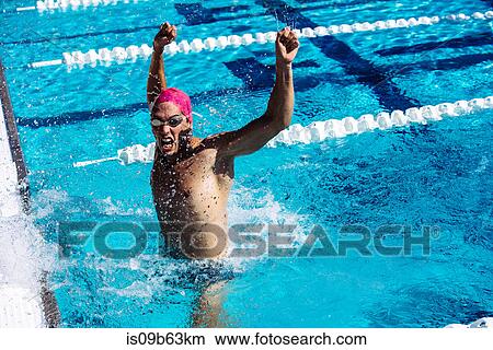 Swimmer in water in pool gesturing triumph View Large Photo Image Picture - Swimmer in water in pool gesturing triumph. Fotosearch