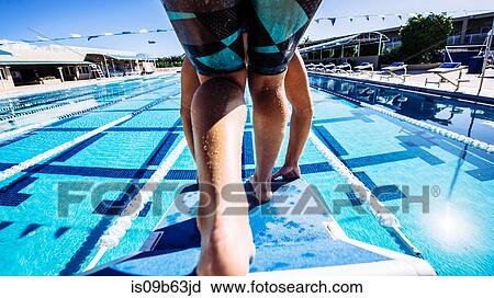 Stock Image - Swimmer on pool diving board. Fotosearch