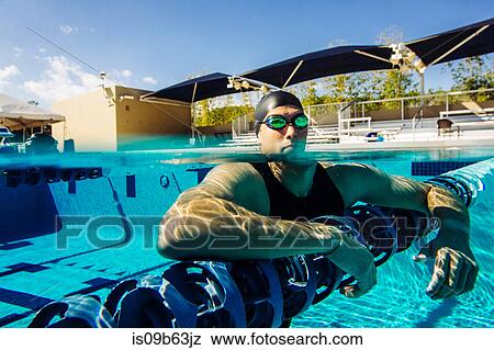 Swimmer resting on lane divider in pool View Large Photo Image Stock Photo - Swimmer resting on lane divider in pool. Fotosearch