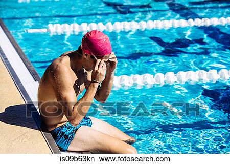 Swimmer sitting at end of pool View Large Photo Image Picture - Swimmer sitting at end of pool. Fotosearch
