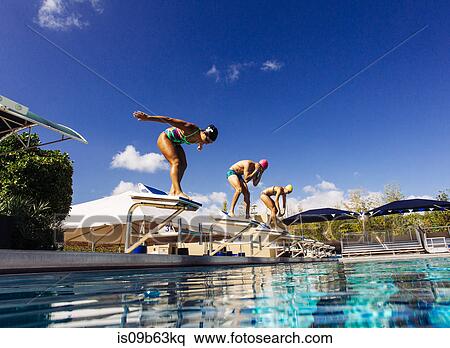 Swimmers on pool diving board View Large Photo Image Stock Photography - Swimmers on pool diving board. Fotosearch
